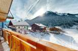 Experience the charm of alpine living with this stunning property, offering breathtaking views of snow-capped mountains and picturesque chalets.