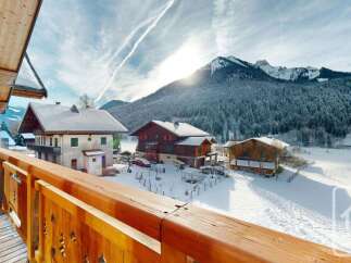 Experience the charm of alpine living with this stunning property, offering breathtaking views of snow-capped mountains and picturesque chalets.