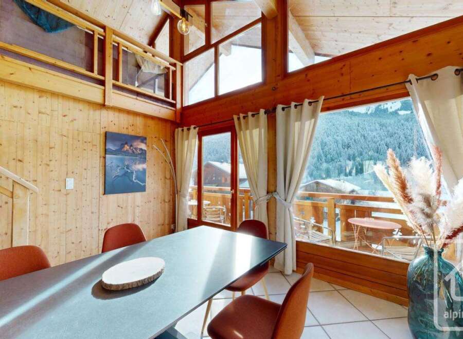 Experience the charm of this stunning property, featuring a beautifully designed dining area with a modern table and comfortable seating.