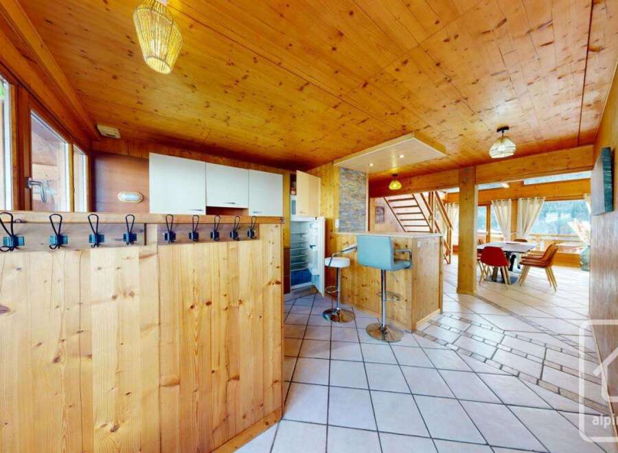 Discover the charm of this stunning property, featuring a warm and inviting interior with beautiful wooden accents throughout.