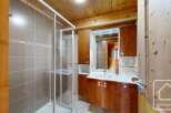 Discover this charming bathroom featuring a sleek glass shower enclosure and elegant tile work.