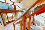 Experience the charm of this stunning property, featuring a beautifully crafted wooden staircase and a cozy interior.