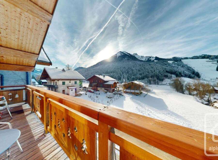 Enjoy breathtaking mountain views from this charming chalet balcony.