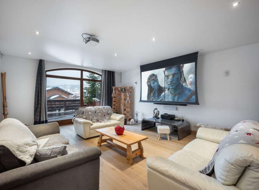 Experience luxury living in this stunning property, featuring a state-of-the-art home theater with a large screen perfect for movie nights.