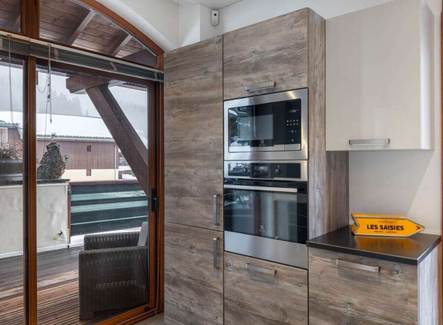 This stunning kitchen boasts modern appliances and stylish cabinetry, perfect for culinary enthusiasts.