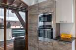 This stunning kitchen boasts modern appliances and stylish cabinetry, perfect for culinary enthusiasts.