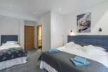 This cozy bedroom features two beds, perfect for a family or group of friends.