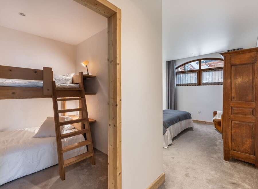 Discover the charm of this inviting bedroom, featuring a cozy bunk bed setup perfect for family or guests.