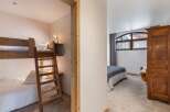 Discover the charm of this inviting bedroom, featuring a cozy bunk bed setup perfect for family or guests.
