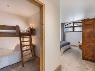 Discover the charm of this inviting bedroom, featuring a cozy bunk bed setup perfect for family or guests.