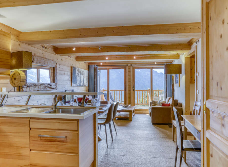 Experience the charm of this stunning property, featuring a cozy living space with wooden accents and a modern kitchen.