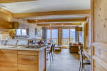 Experience the charm of this stunning property, featuring a cozy living space with wooden accents and a modern kitchen.