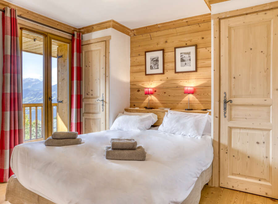 Experience the charm of this cozy bedroom, featuring a warm wooden interior and a comfortable bed.