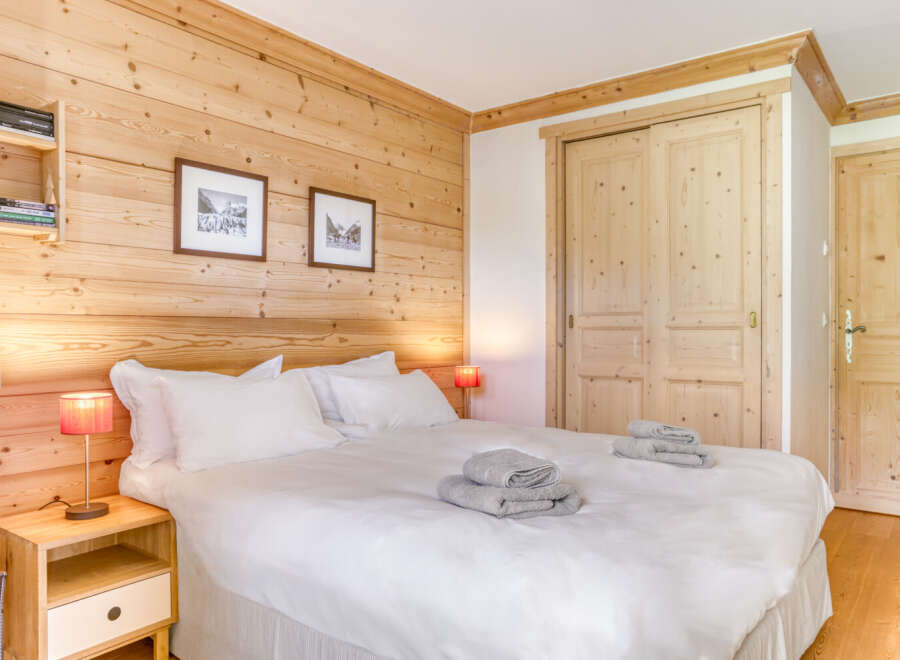 This cozy bedroom features beautiful wooden paneling, creating a warm and inviting atmosphere.