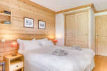 This cozy bedroom features beautiful wooden paneling, creating a warm and inviting atmosphere.