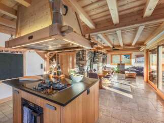 This stunning kitchen boasts a rustic yet modern design, perfect for those seeking a blend of comfort and style.