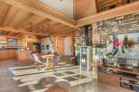 Experience the warmth of this stunning chalet, featuring a cozy fireplace and exposed wooden beams.