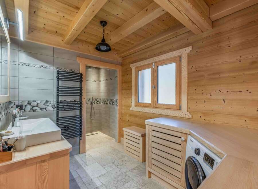Step into this stunning bathroom, where rustic charm meets modern convenience.