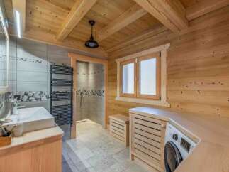 Step into this stunning bathroom, where rustic charm meets modern convenience.