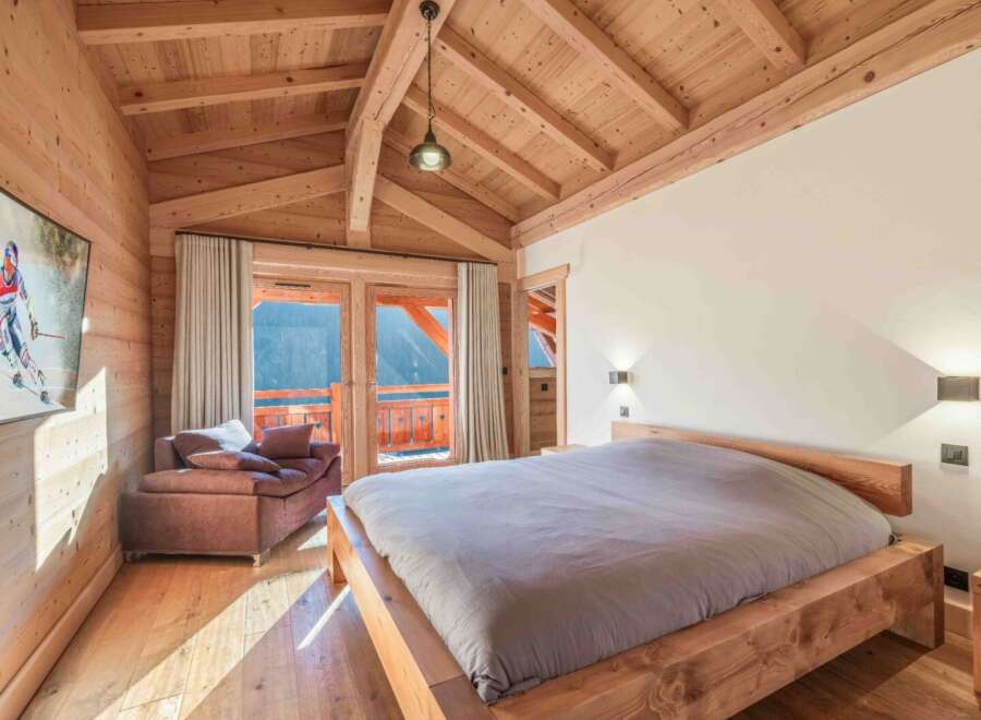 Experience the warmth and charm of this stunning bedroom, featuring a beautiful wooden ceiling and walls.
