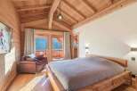 Experience the warmth and charm of this stunning bedroom, featuring a beautiful wooden ceiling and walls.