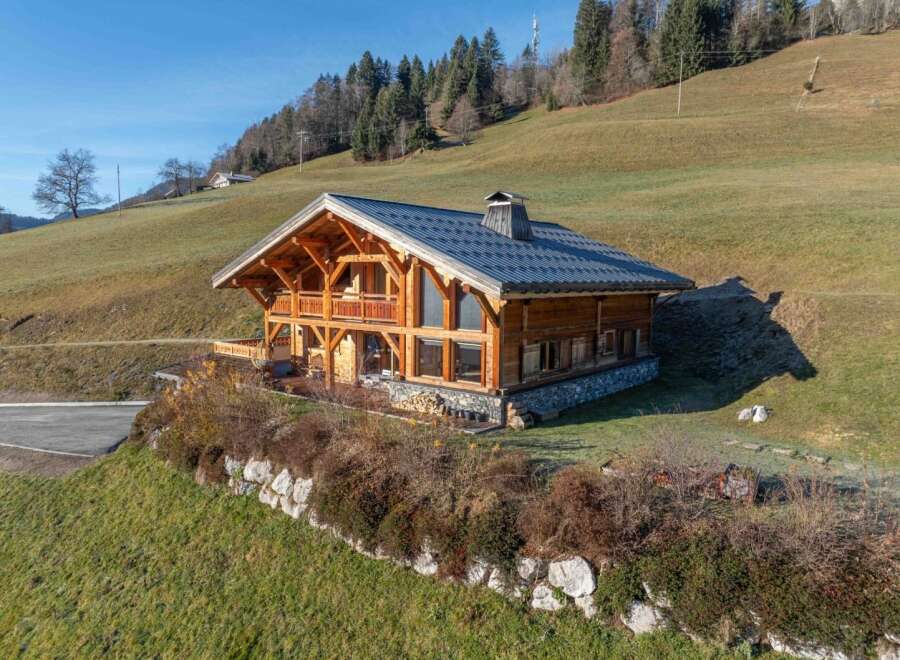 Nestled in a serene landscape, this stunning wooden chalet offers a perfect blend of rustic charm and modern comfort.
