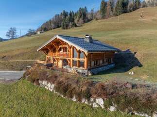 Nestled in a serene landscape, this stunning wooden chalet offers a perfect blend of rustic charm and modern comfort.