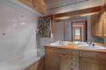 This stunning bathroom boasts a luxurious design with a double vanity and a spacious bathtub.