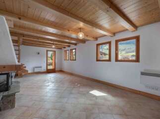 Discover the charm of this inviting living space, featuring a stunning wooden ceiling and exposed beams that add warmth and character.
