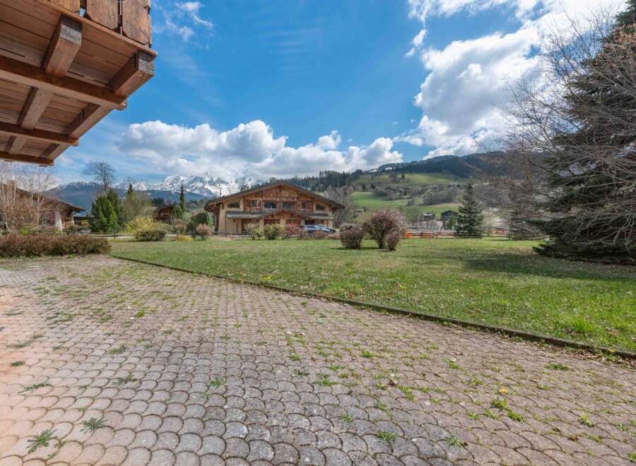 Discover a stunning property nestled in a picturesque landscape, boasting a charming wooden facade and ample outdoor space.