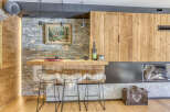 Experience rustic elegance in this stunning property, featuring a beautifully designed bar area with stylish wire chairs and a cozy fireplace.