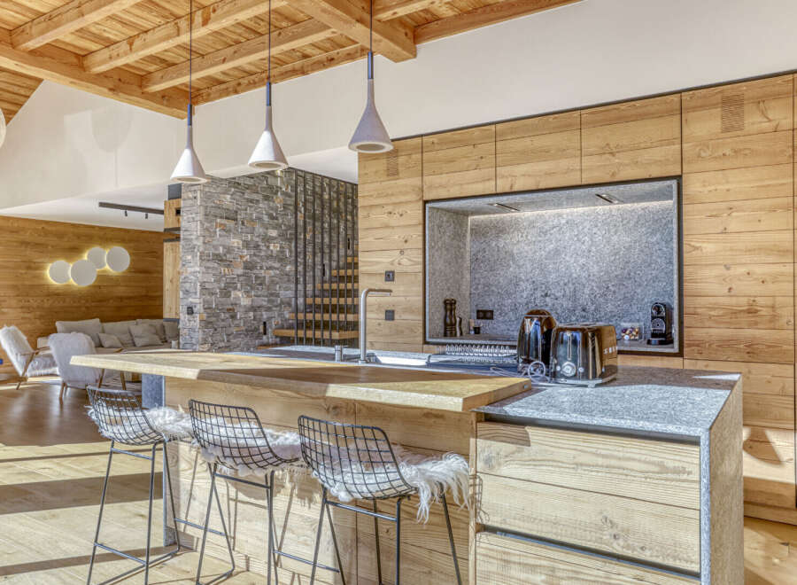 This stunning kitchen showcases a modern design with a rustic touch, perfect for a luxurious living experience.