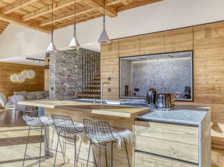 This stunning kitchen showcases a modern design with a rustic touch, perfect for a luxurious living experience.