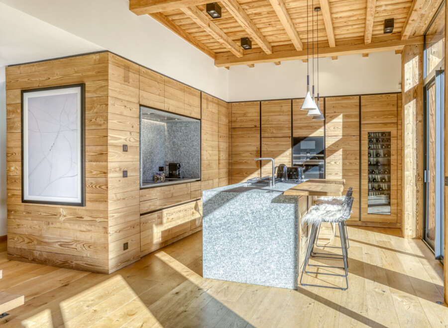 This stunning kitchen showcases a modern design with a rustic touch, perfect for a luxurious living experience.