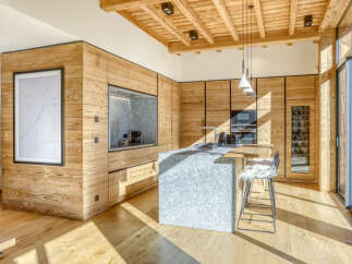 This stunning kitchen showcases a modern design with a rustic touch, perfect for a luxurious living experience.