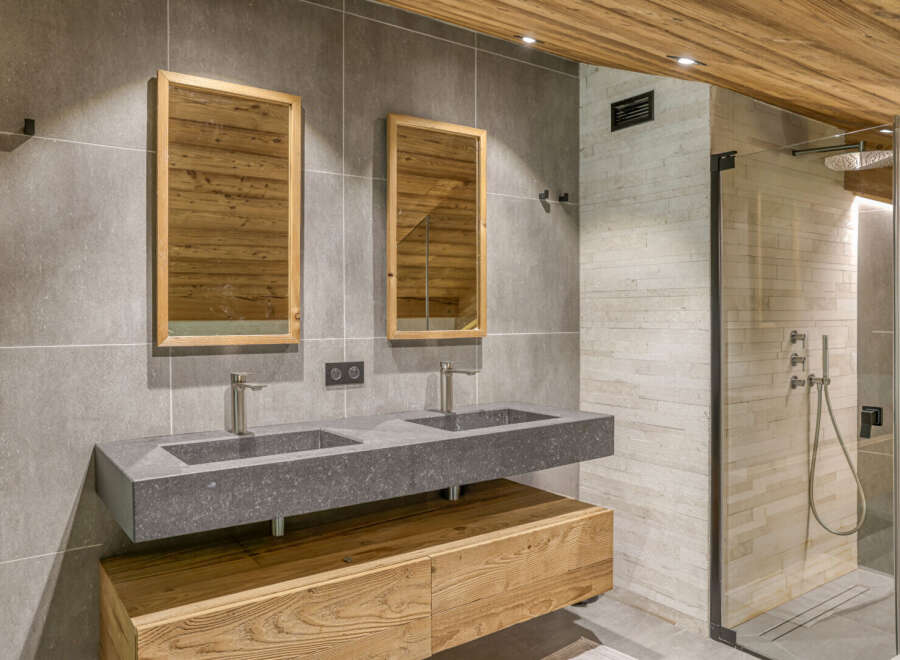 Experience luxury in this stunning bathroom featuring a sleek double vanity with modern fixtures.
