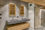 Experience luxury in this stunning bathroom featuring a sleek double vanity with modern fixtures.