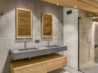Experience luxury in this stunning bathroom featuring a sleek double vanity with modern fixtures.