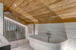 Experience luxury in this stunning bathroom featuring a unique wooden ceiling and modern design.