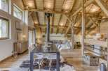 Experience rustic elegance in this stunning property, featuring exposed wooden beams and a cozy fireplace.