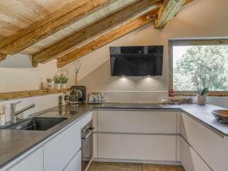 This stunning kitchen features a rustic, yet modern design, perfect for any home.