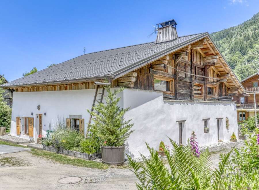 Discover the charm of this stunning property, featuring a unique blend of rustic wooden architecture and modern white stucco.