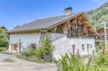 Discover the charm of this stunning property, featuring a unique blend of rustic wooden architecture and modern white stucco.