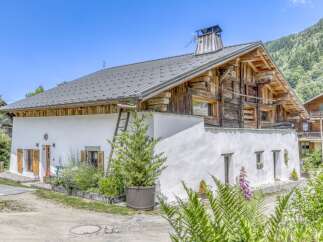 Discover the charm of this stunning property, featuring a unique blend of rustic wooden architecture and modern white stucco.
