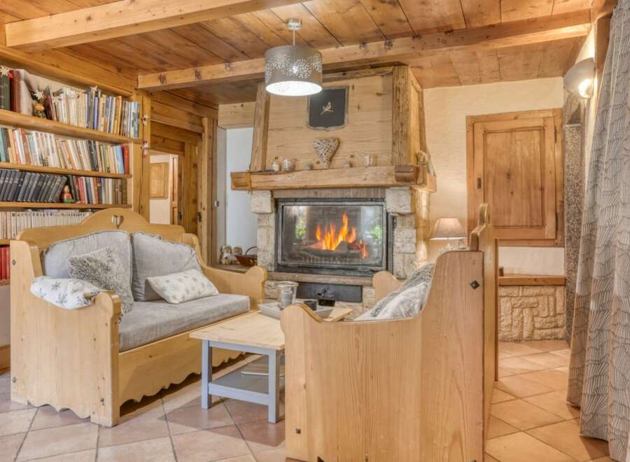 Experience the warmth of this charming living space, featuring a cozy fireplace and inviting seating.