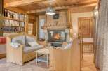 Experience the warmth of this charming living space, featuring a cozy fireplace and inviting seating.