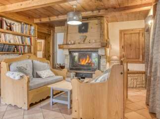 Experience the warmth of this charming living space, featuring a cozy fireplace and inviting seating.