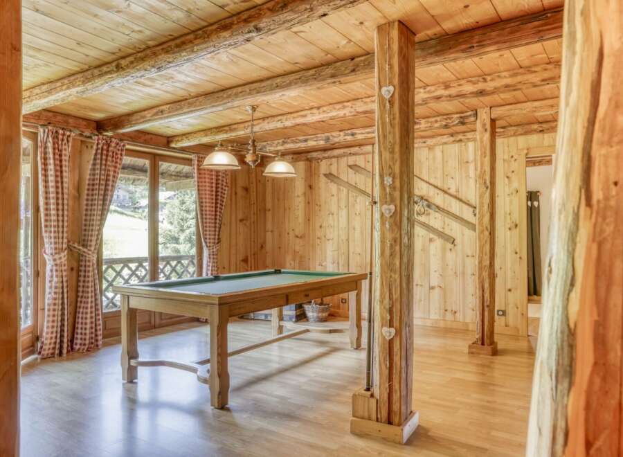 This stunning property boasts a rustic charm with its wooden interior and inviting ambiance.