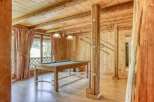This stunning property boasts a rustic charm with its wooden interior and inviting ambiance.