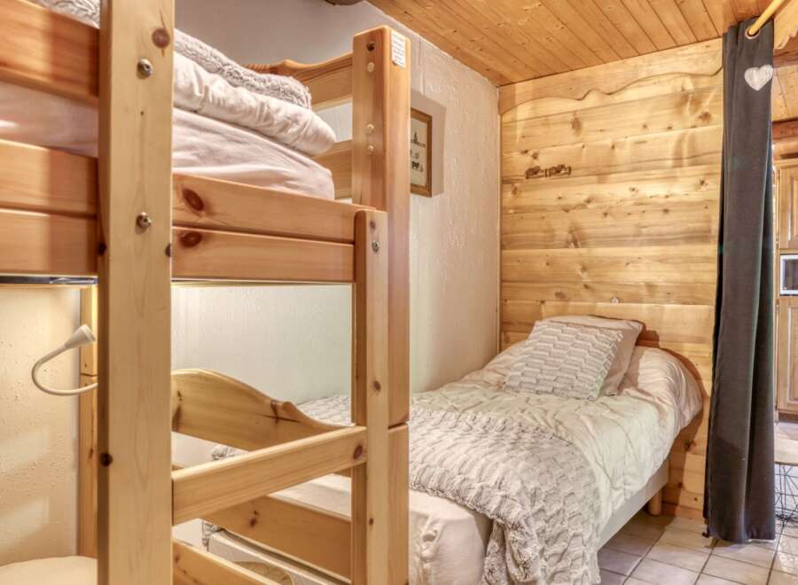 Cozy and inviting, this bedroom features a charming bunk bed, perfect for accommodating guests or family.